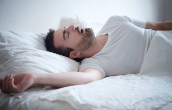 Snoring man sleeping with his mouth open